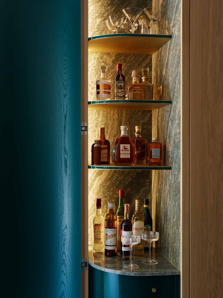 Lit drinks cabinet set into oak joinery