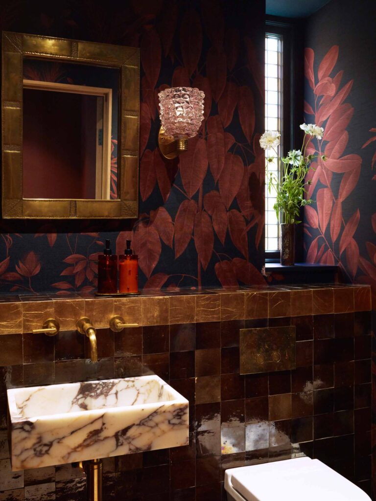 Cloakroom with marble basin and bronze tiles
