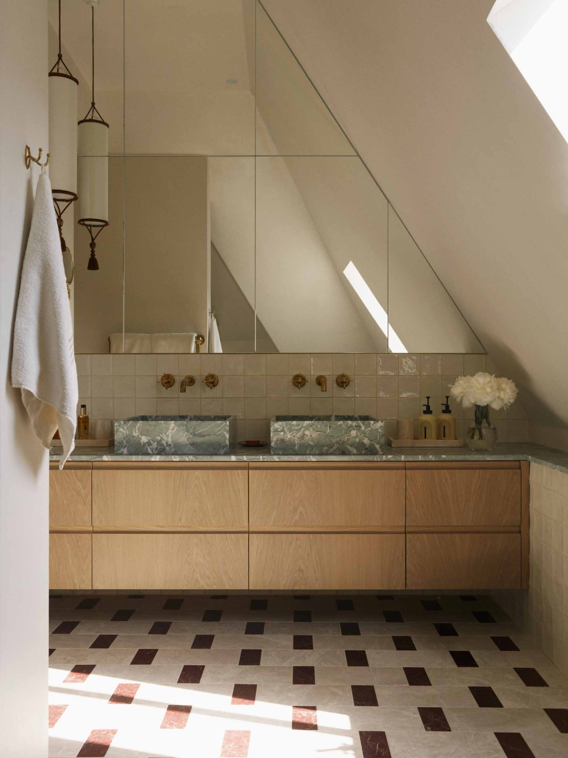 Loft shower room with patterned floor tiles